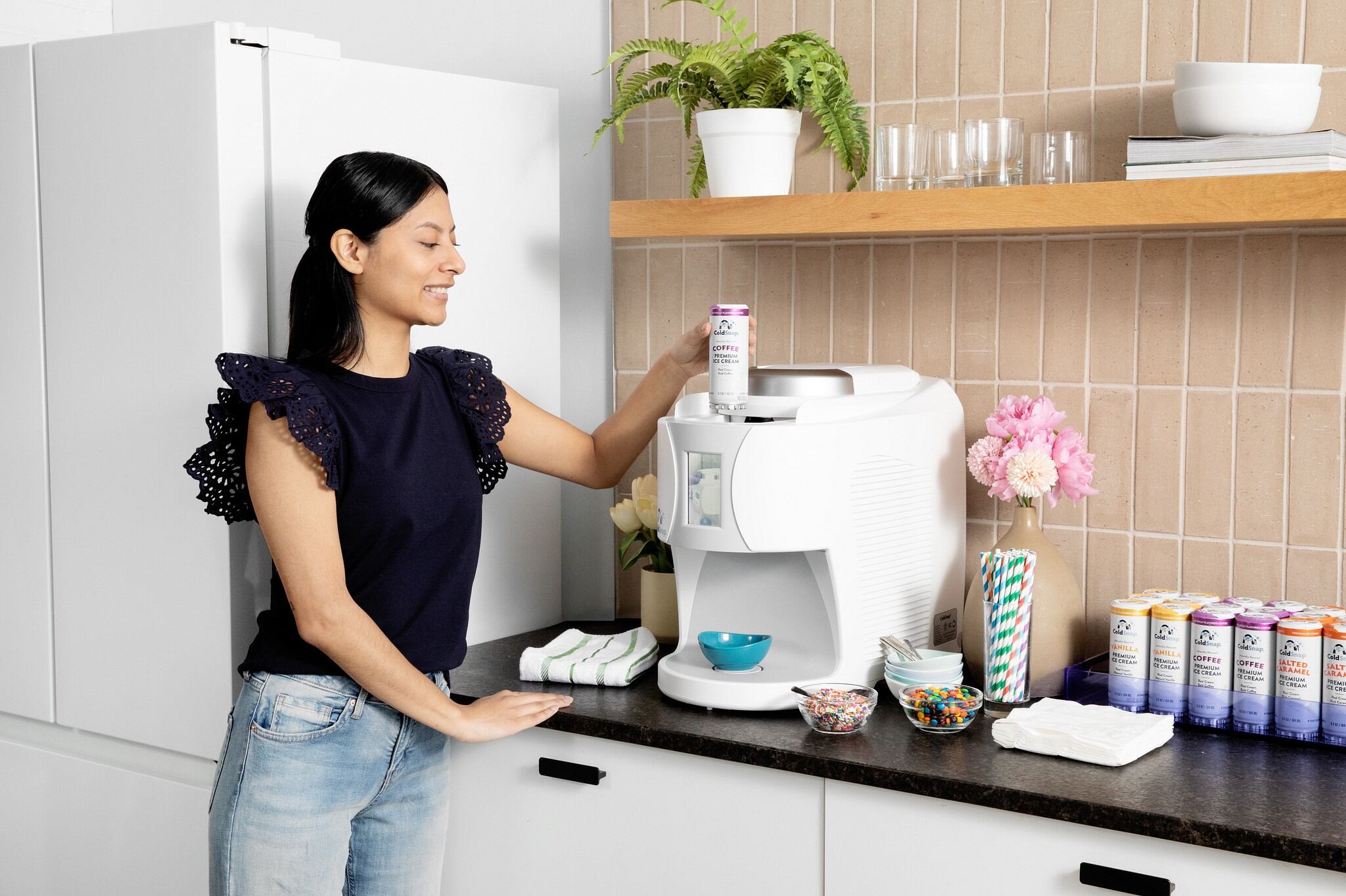 A woman inserting a ColdSnap pod into the ColdSnap machine