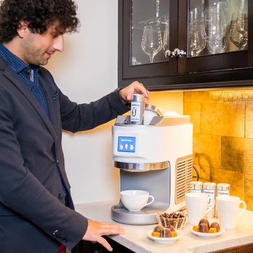 A Man dispensing ice cream using a ColdSnap machine