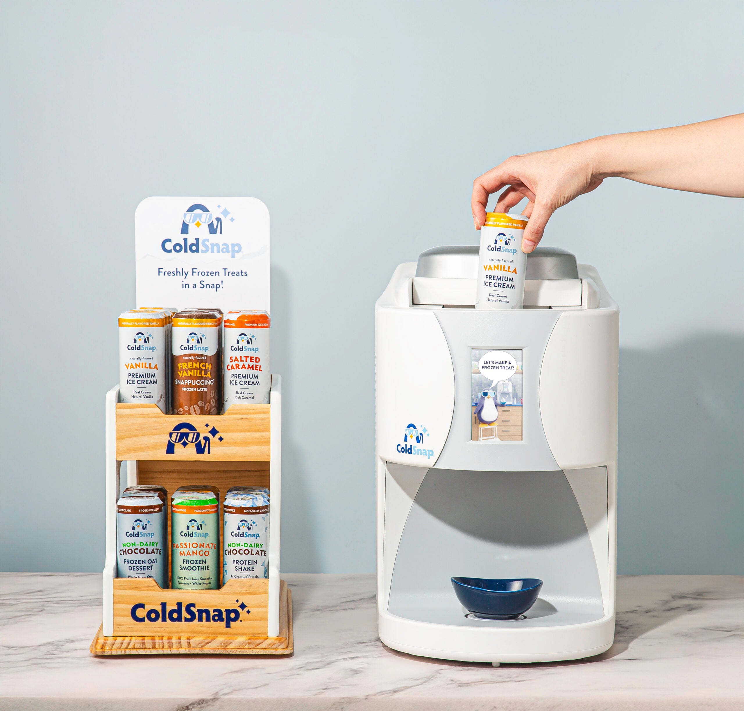 ColdSnap product display with a hand placing a pod on top of a white machine.