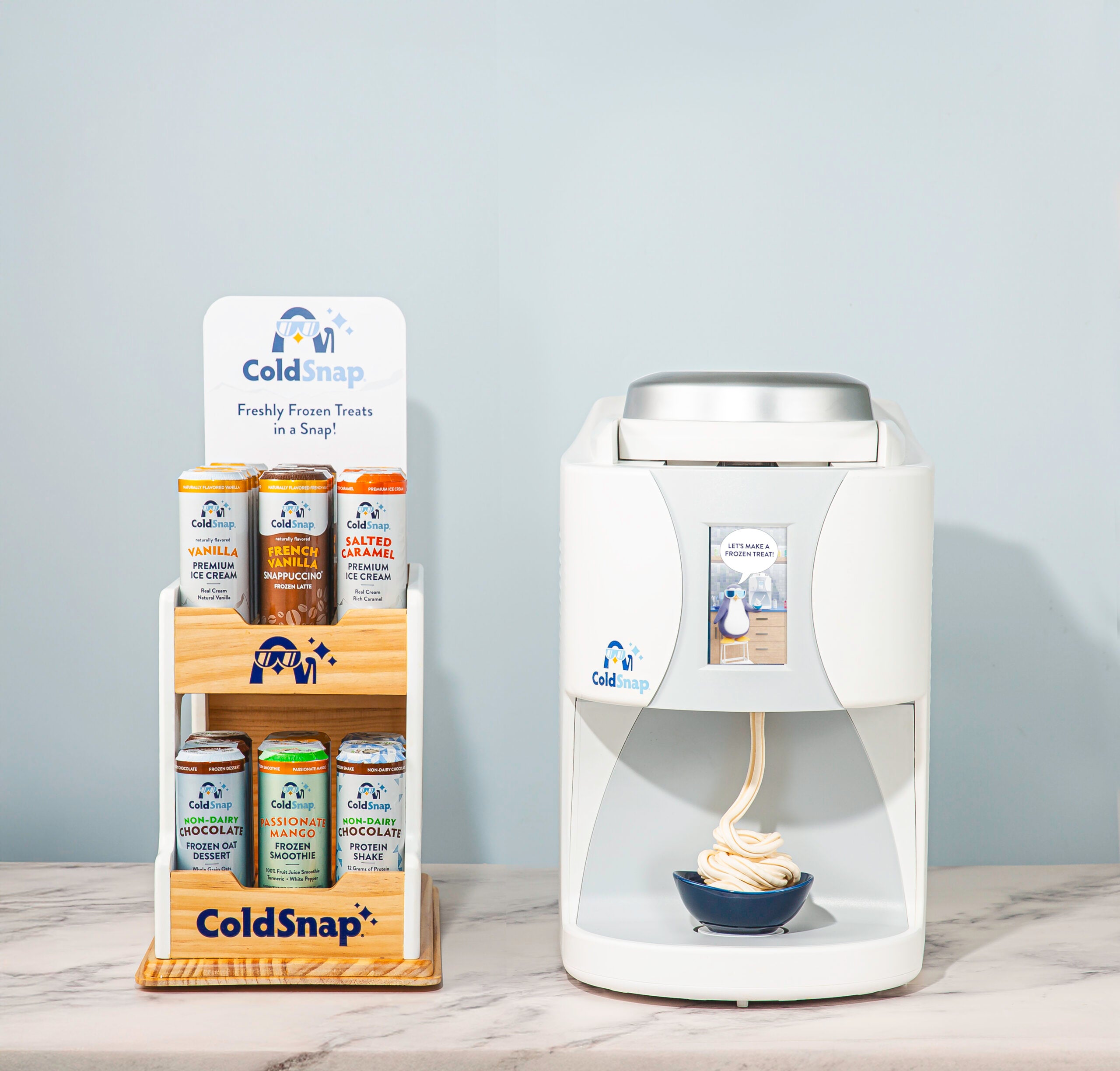 ColdSnap ice cream dispenser with a display of ColdSnap ice cream containers on a gray background.