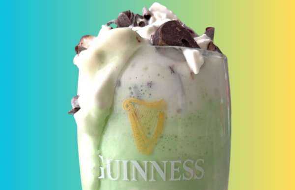Green ColdSnap Shamrock shake with whipped cream and chocolate shavings in a glass, featuring the Guinness logo on a gradient background.