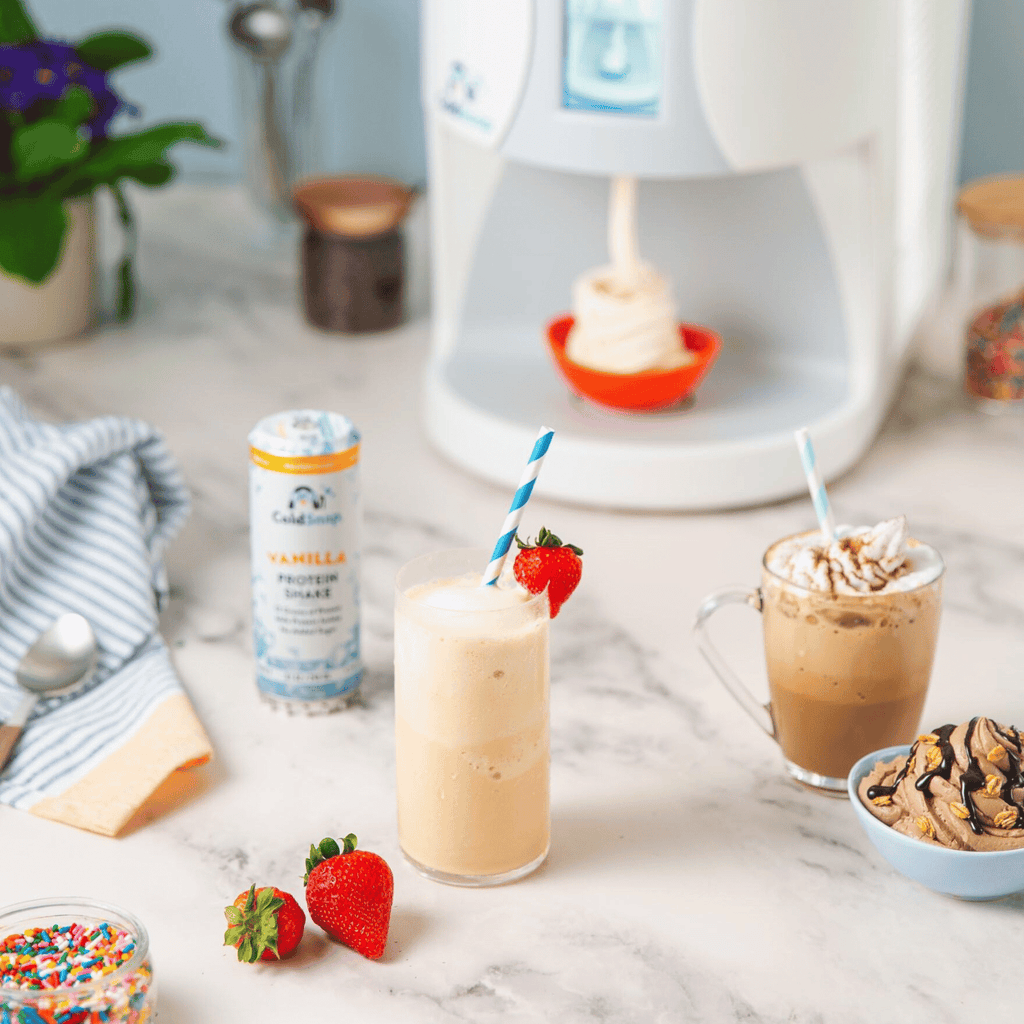 ColdSnap® frozen treat machine dispensing ice cream with two prepared cold snap drinks in the foreground