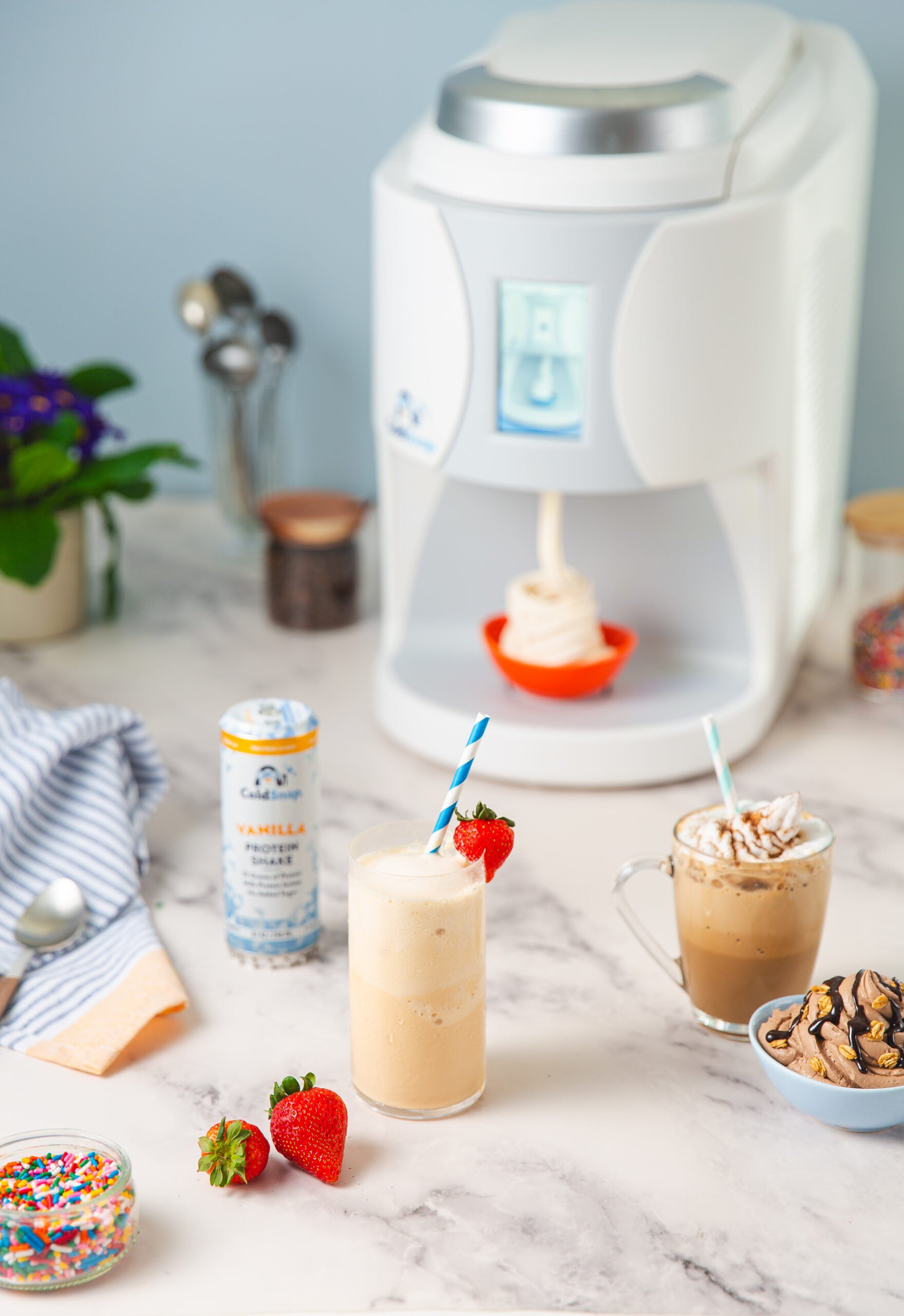 ColdSnap machine on a  marble countertop with two ColdSnap beverages.